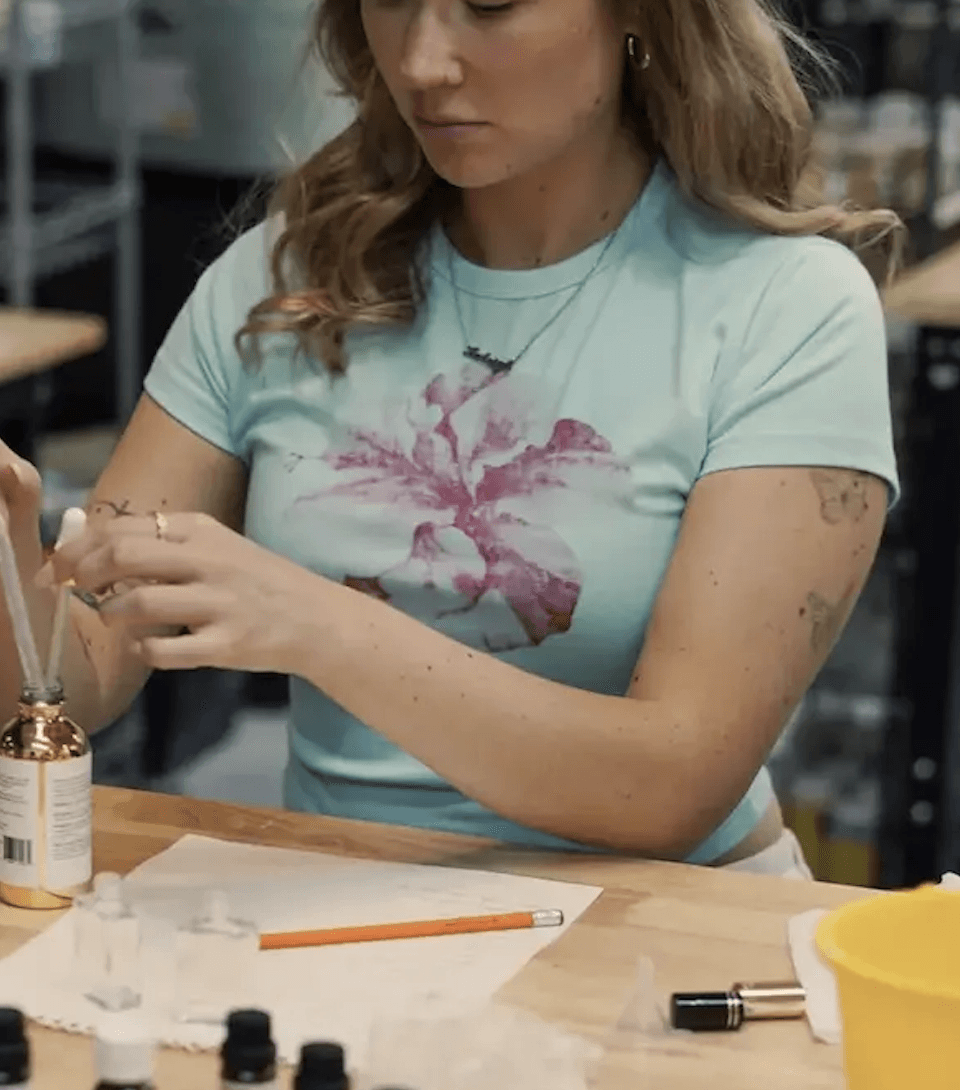 A guest carefully blending drops of fragrance with a pipette