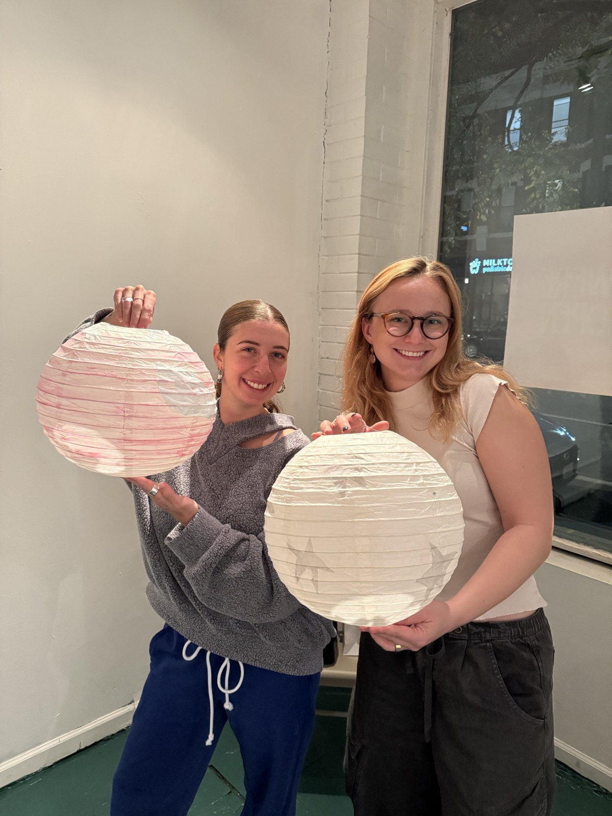 Two friends with a star lantern and a pink lantern